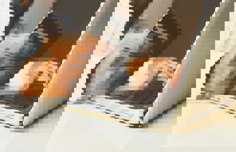 Man holding your bank card and computer in front of him